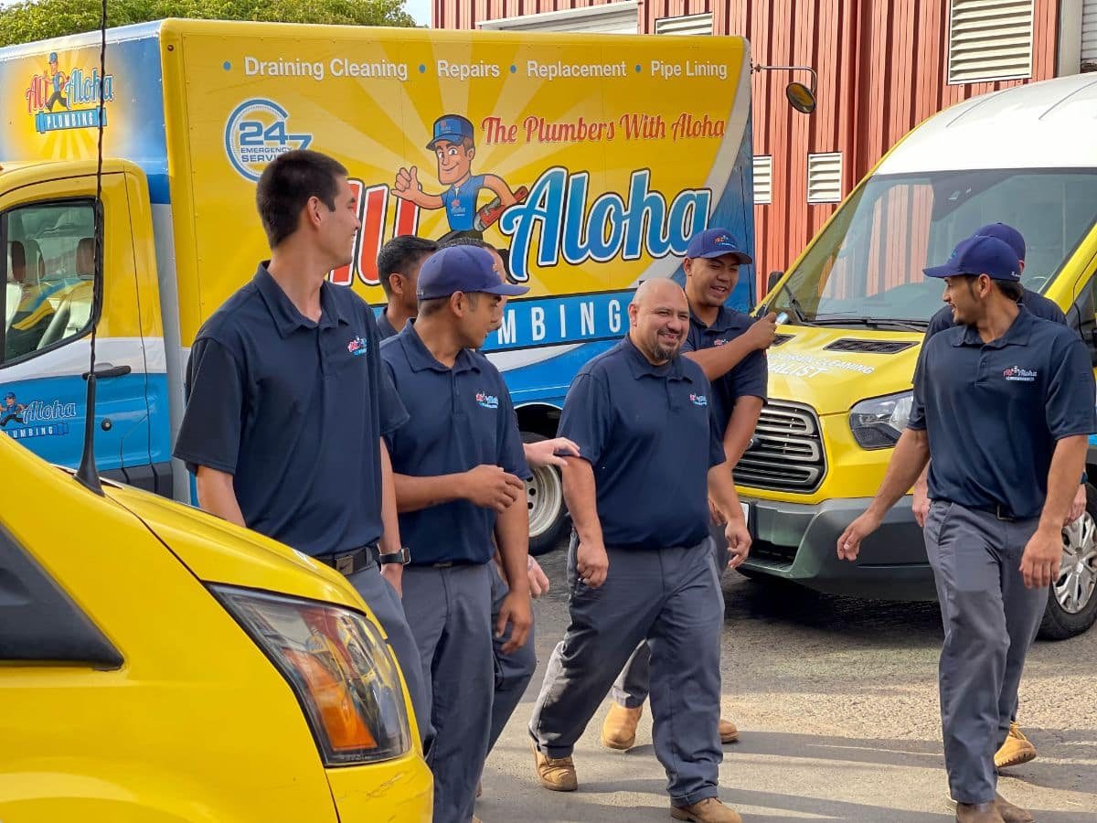 All Aloha Plumbing technicians gathered by company vehicles
