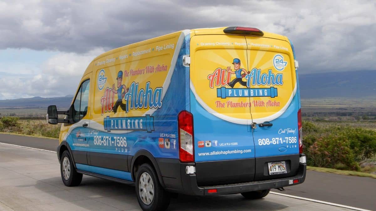 All Aloha Plumbing van parked on a Maui road with mountains behind it